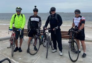 Four cyclists at Sunset Beach in Tarpon Springs